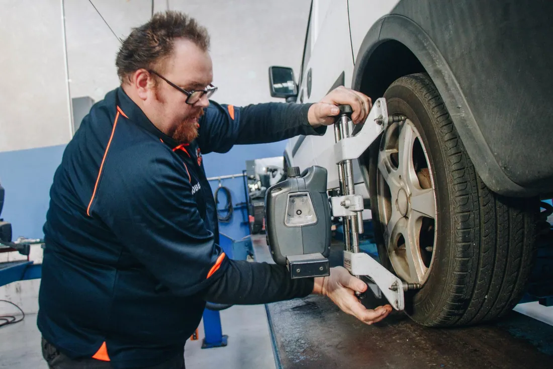 AutoTreads technician aligning a heavy vehicle with staff in the East Tamaki workshop