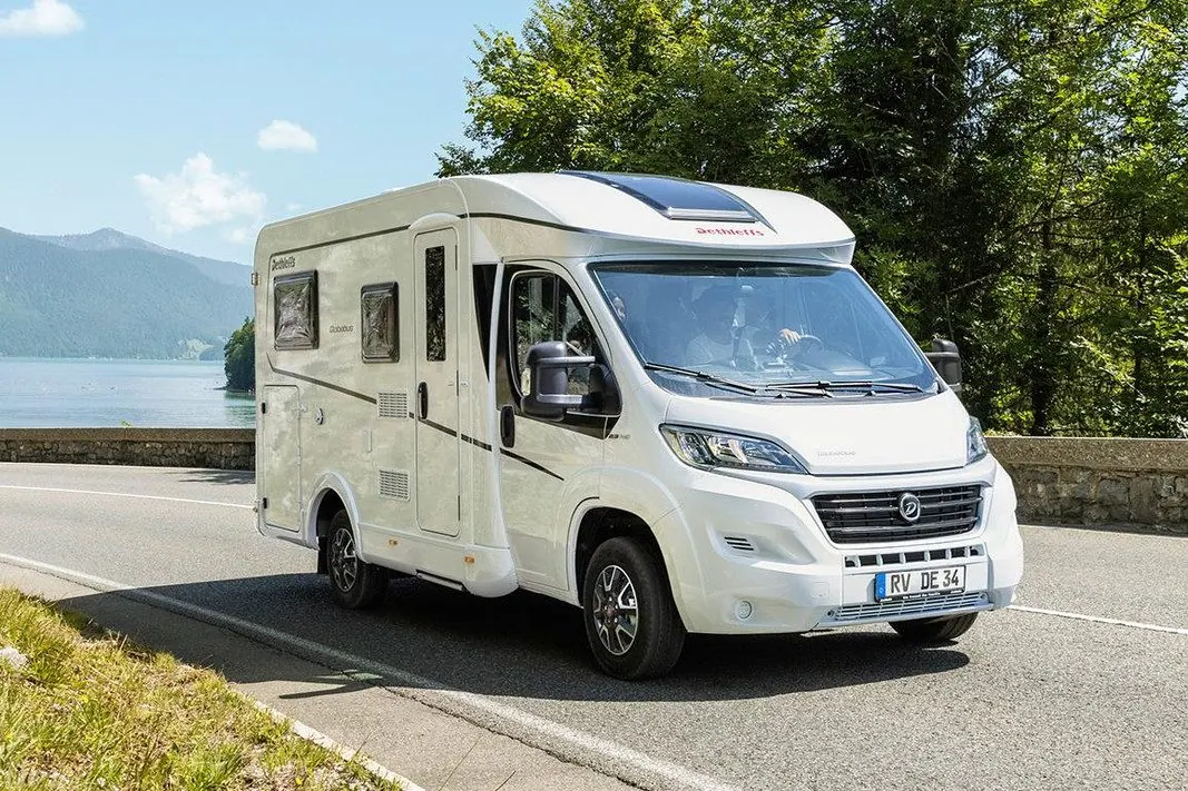 Motorhome travelling along a scenic New Zealand coastal road