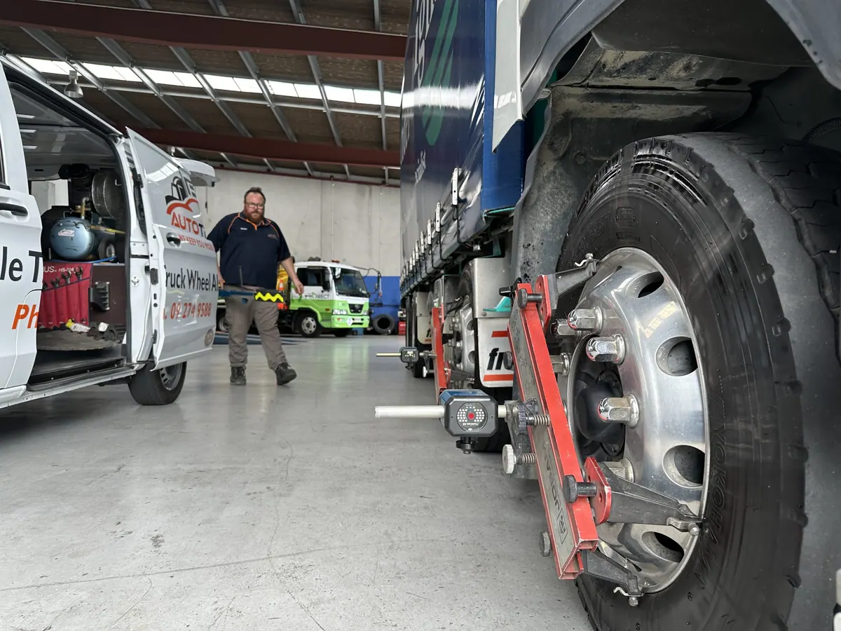 Vehicle on an alignment rig with a sensor target fitted to the wheel