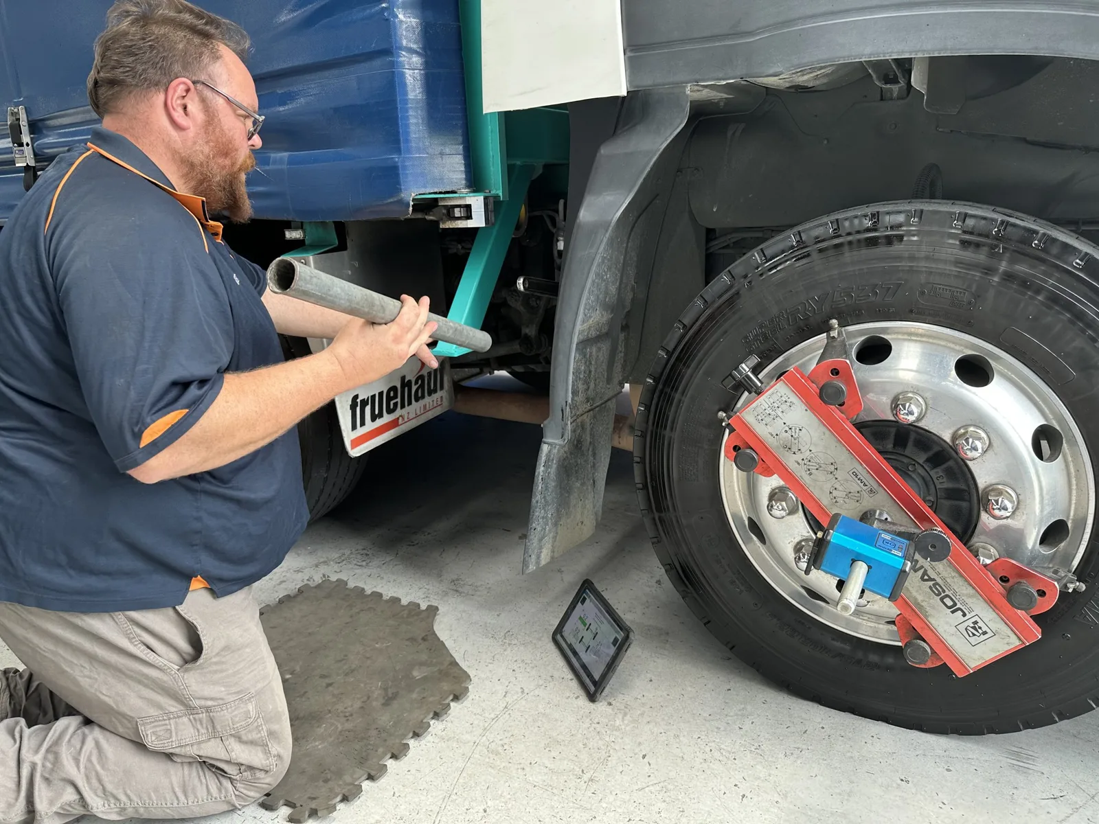 AutoTreads technician inspecting a heavy truck tyre and wheel hub