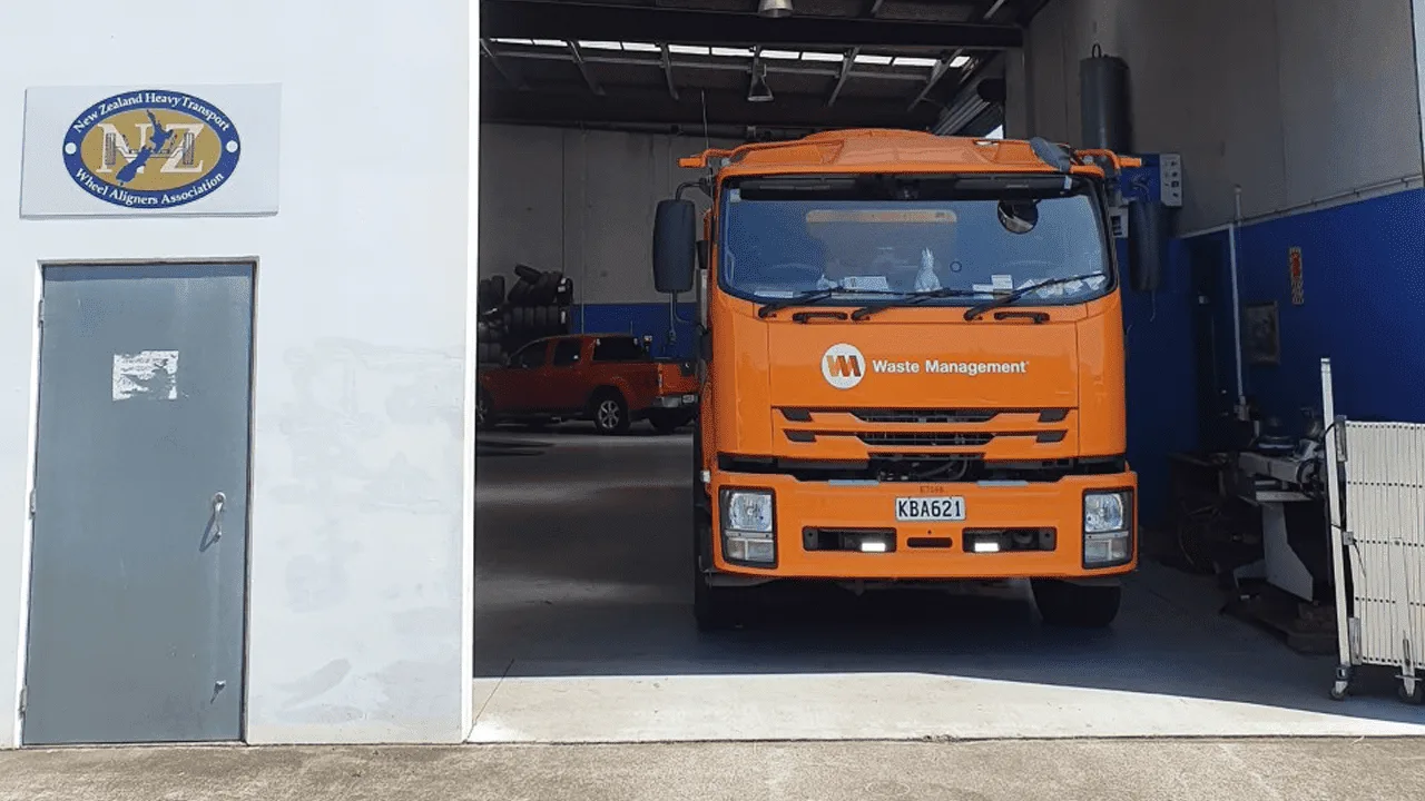 Orange truck cab in the AutoTreads alignment bay