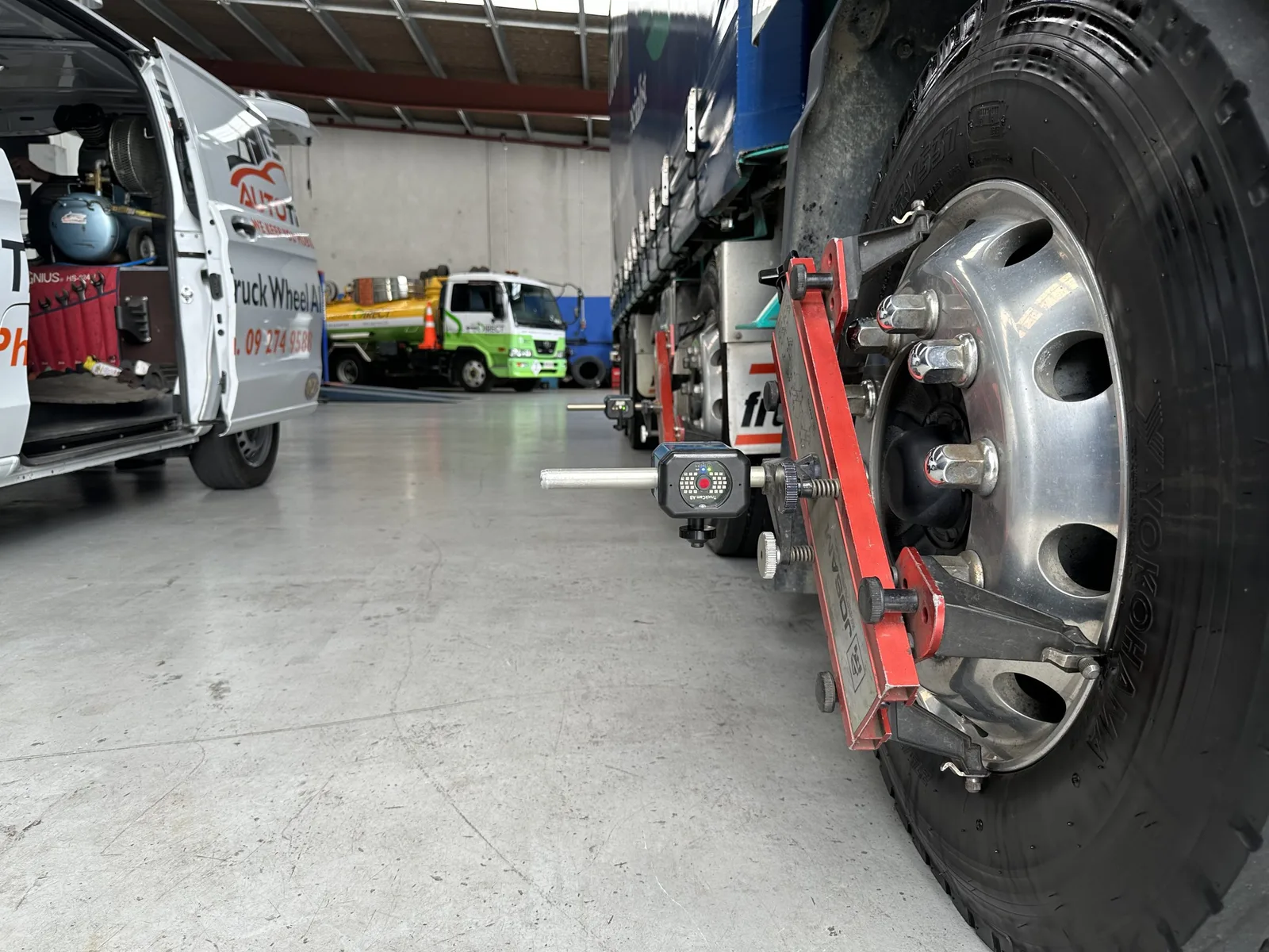 Close-up of a truck dual-wheel set during an alignment check at AutoTreads