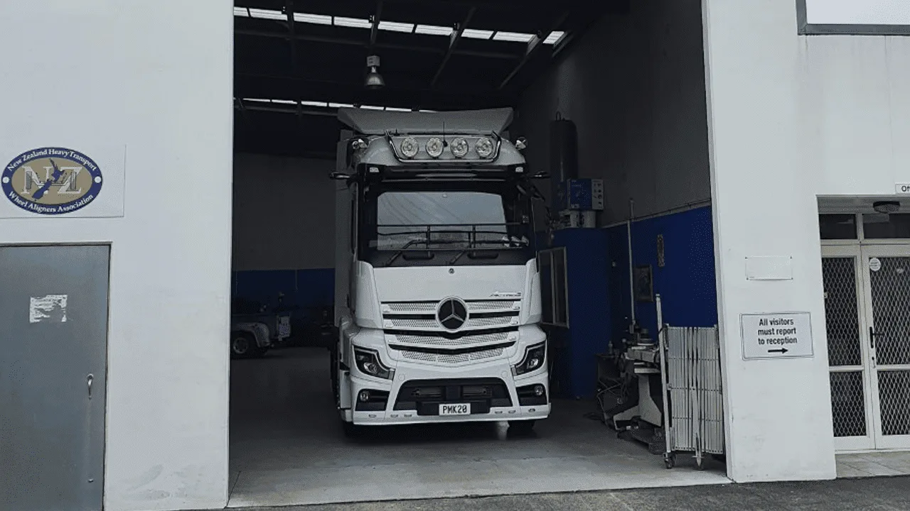 White commercial truck in the AutoTreads alignment bay